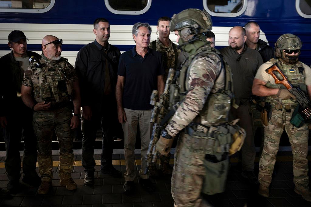 U.S. Secretary of State Antony Blinken, center, stands next to Ukrainian security forces before departing a train station in Kyiv, Ukraine