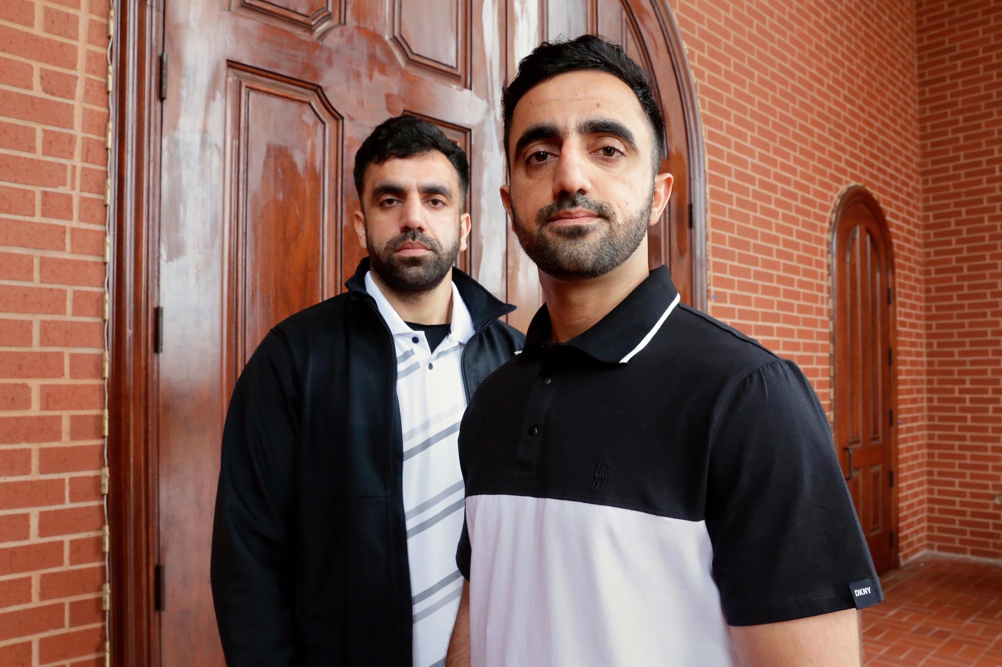 Two brothers posing outside of a courtroom in Houston.