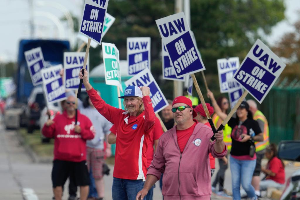 The auto workers' strike against Detroit's Big Three went into its fourth day on Monday with no signs of an early breakthrough and against the threat that the walkout could soon spread.  In a sign of the potential economic and political of a long strike, President Joe Biden is sending two top administration officials to Detroit this week to meet with both sides. Biden has sided with the UAW in brief public comments, saying that the automakers have not fairly shared their record profits with workers.  An administration official said Monday that acting Labor Secretary Julie Su and senior aide Gene Sperling will not serve as mediators — they won't be at the bargaining table — but are going to Detroit “to help support the negotiations in any way the parties feel is constructive.” The official was not authorized to discuss private discussions and spoke anonymously.  UAW President Shawn Fain said Monday that the Biden administration won't broker a deal.  “This is our battle. Our members are out there manning the picket lines," Fain said on MSNBC. "This battle is not about the president, it’s not about the former president.”  Rather than launching an all-out strike of its 146,000 members, the union opted to target three factories — one at each company — a plan that could make the union's $825 million strike fund last longer.  A key feature of the strategy is the threat of escalating the strike if the union is unhappy with the pace of bargaining. On Friday, Fain said more factories could be targeted: “It could be in a day, it could be in a week.”