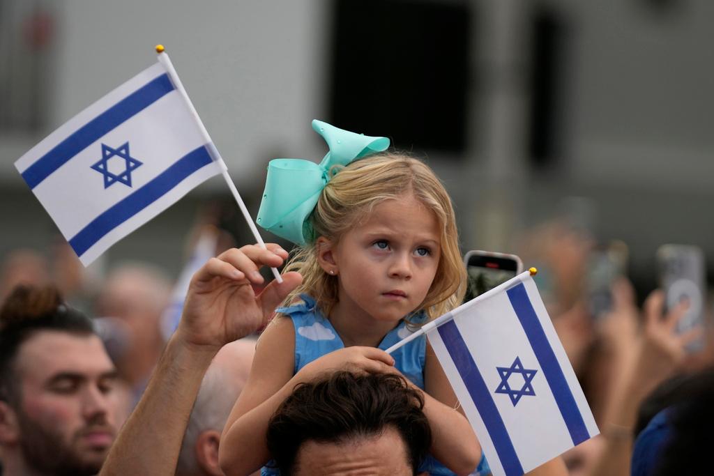 A young girl looks on as she attends a rally in support of Israel, at the Holocaust Memorial Miami Beach