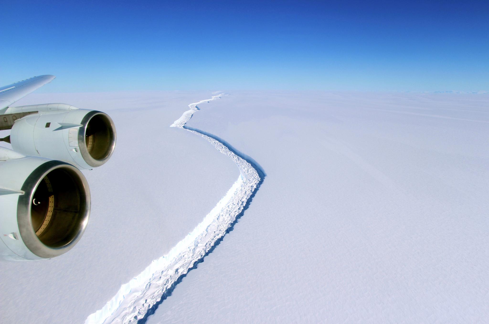 Two jet engines visible over a cracked ice shelf