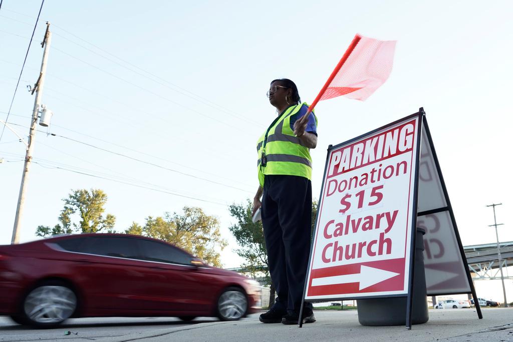 Person directs vehicles into the Calvary Baptist Church parking lot