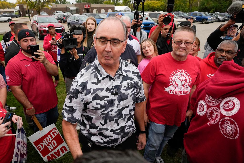 nited Auto Workers President Shawn Fain talks with members picketing near a General Motors Assembly Plant in Delta Township, Michigan