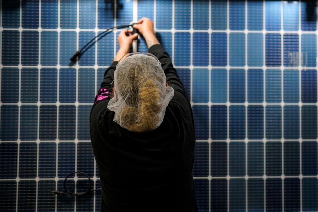 An employee works on a solar panel inside the Hanwha Qcells Solar plant on Oct. 16, 2023, in Dalton, Ga.