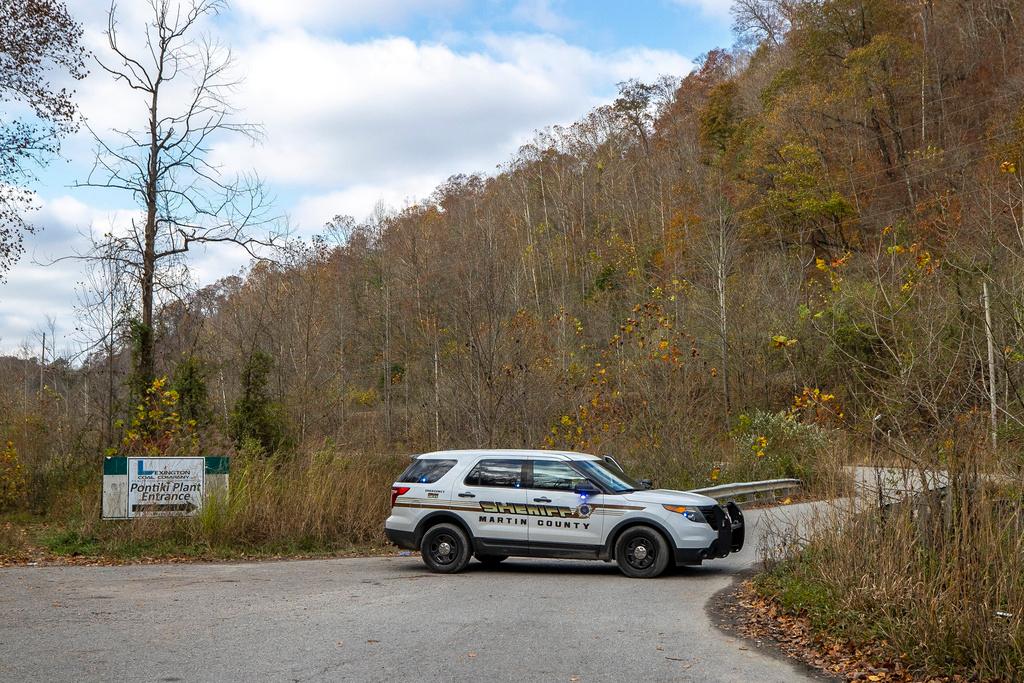 A sheriff's vehicle blocks a road leading to the area where a rescue operation is underway for two workers trapped inside a collapsed coal preparation plant in Martin County, south of Inez, Ky., on Wednesday, Nov. 1, 2023.