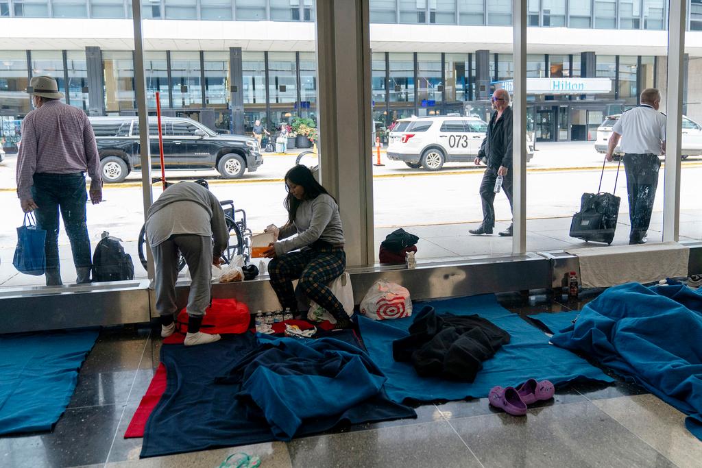 Run by a private firm hired by the city, migrants stay in a makeshift shelter at O'Hare International Airport in Chicago