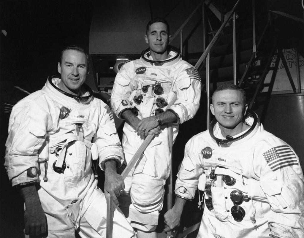 Apollo 8 astronauts, from left, James Lovell, command module pilot; William Anders, lunar module pilot; and Frank Borman, commander; stand in front of mission simulator