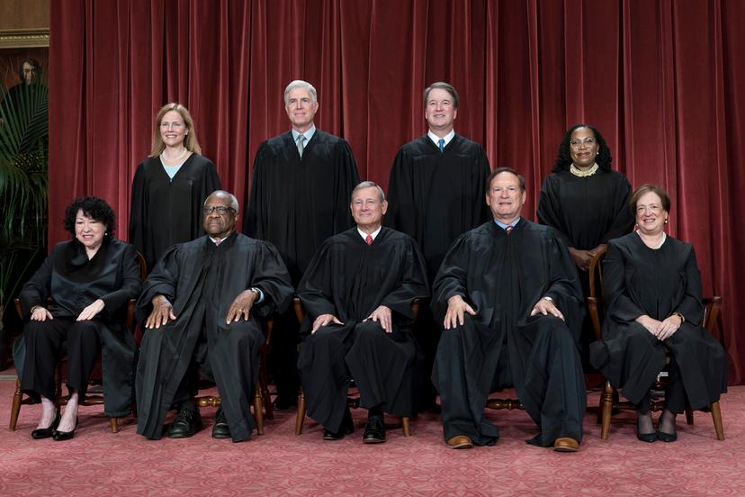 FILE - Members of the Supreme Court sit for a new group portrait following the addition of Associate Justice Ketanji Brown Jackson, at the Supreme Court building in Washington, Oct. 7, 2022. Bottom row, from left, Justice Sonia Sotomayor, Justice Clarence Thomas, Chief Justice John Roberts, Justice Samuel Alito, and Justice Elena Kagan. Top row, from left, Justice Amy Coney Barrett, Justice Neil Gorsuch, Justice Brett Kavanaugh, and Justice Ketanji Brown Jackson. The Supreme Court is adopting its first code of ethics, in the face of sustained criticism over undisclosed trips and gifts from wealthy benefactors to some justices. The policy was issued by the court Monday.