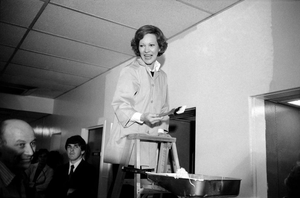 First lady Rosalynn Carter takes a brush to help out with some wall painting during her visit to District of Columbia General Hospital in Washington, May 16, 1978.