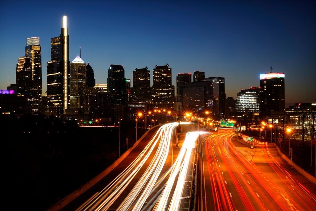 In this image made with a long exposure, motor vehicles move along Interstate 76 ahead of the Thanksgiving Day holiday in Philadelphia, Wednesday, Nov. 23, 2022.