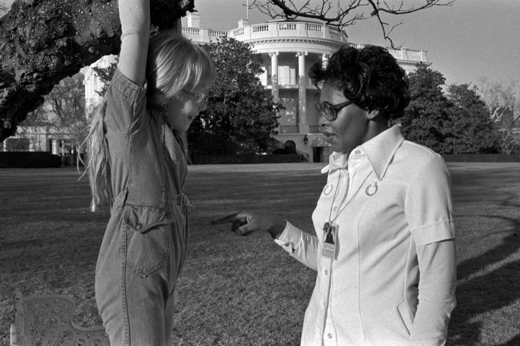 Nanny Mary Fitzpatrick having fun with Amy Carter, hanging on to a White House tree limb (1977)