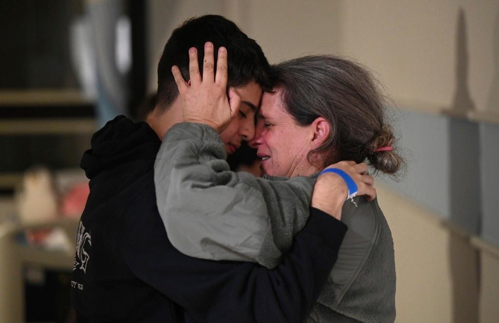  Sharon Hertzman, right, hugging a relative as they reunite at Sheba Medical Center in Ramat Gan, Israel