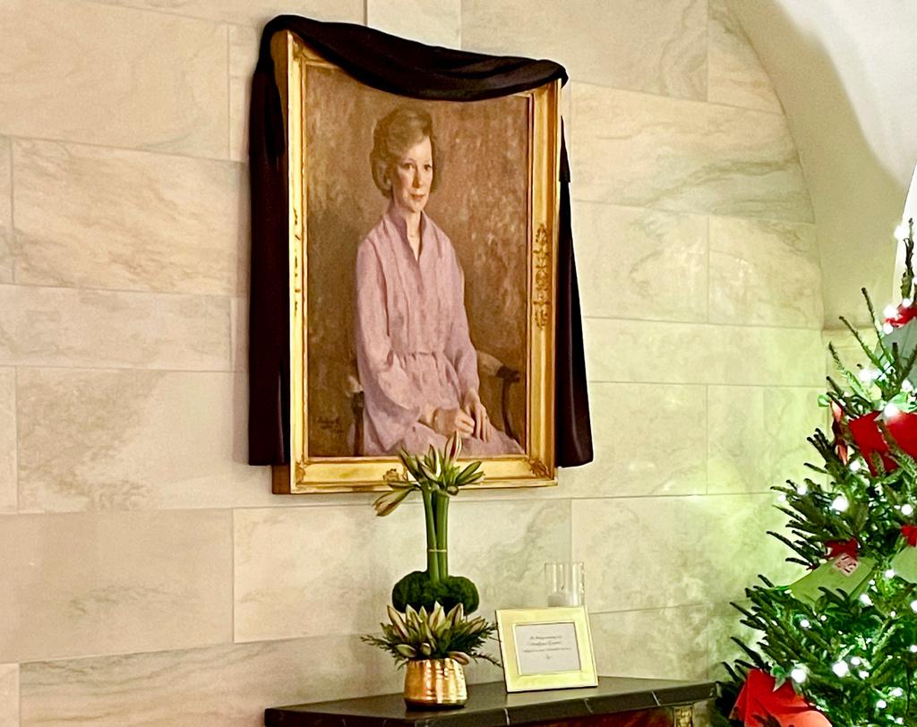 A black mourning drape over the oil canvas portrait of former first lady Rosalynn Carter, painted by American artist George Augusta in 1984