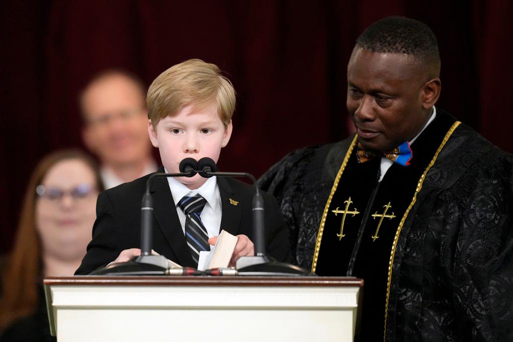 Great grandchild Charles Jeffrey Carter reads a scripture during the funeral service 