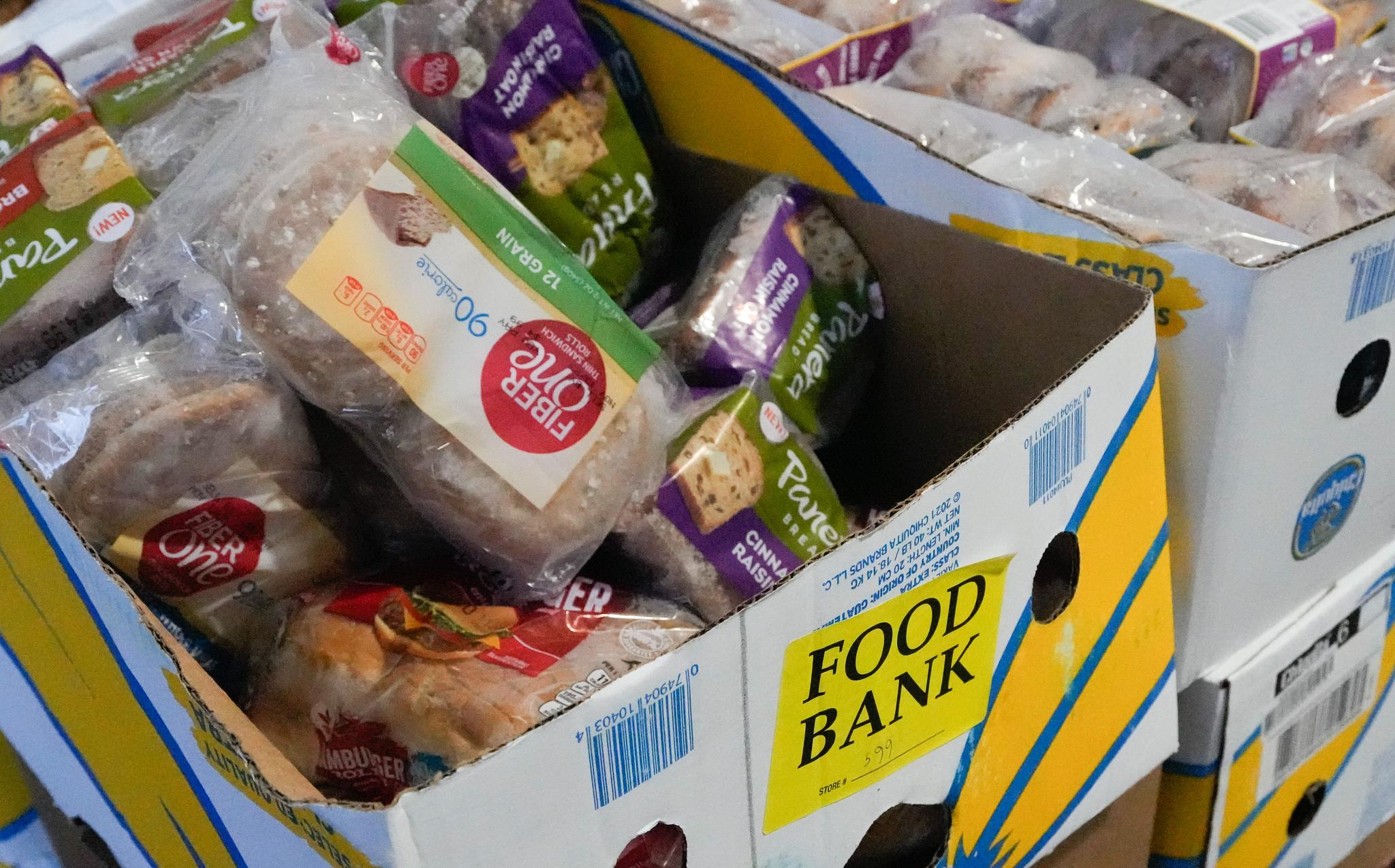 Boxes of food bank donations including bread from Panera