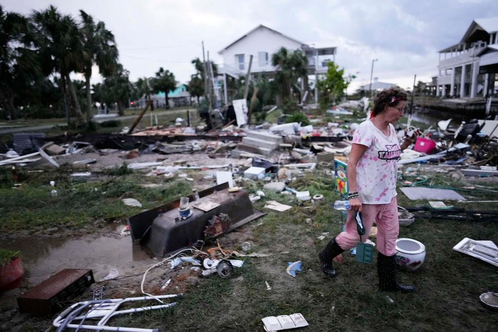 Person walks amidst hurricane debris