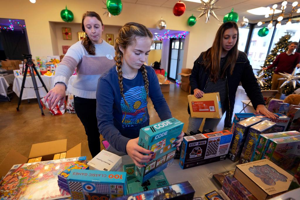 Staff arrange toys at The Toy Store 