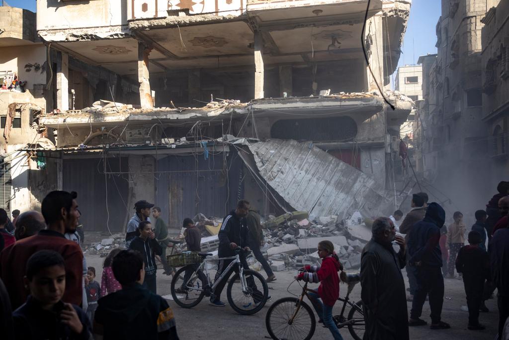 Palestinians check a house destroyed in the Israeli bombardment on Rafah, Gaza Strip