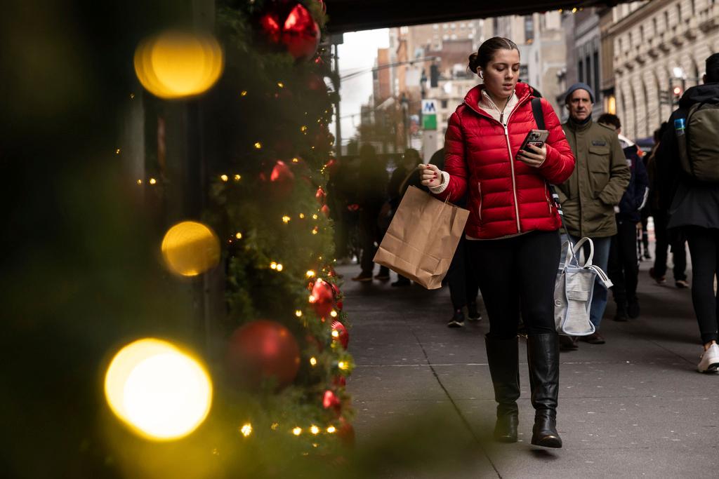 A woman carrying a shopping bag passes Macy's department store in Herald Square in New York