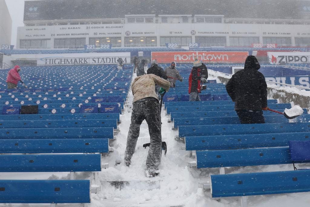 Workers remove snow from Highmark Stadium in Orchard Park, N.Y., Sunday Jan. 14, 2024.