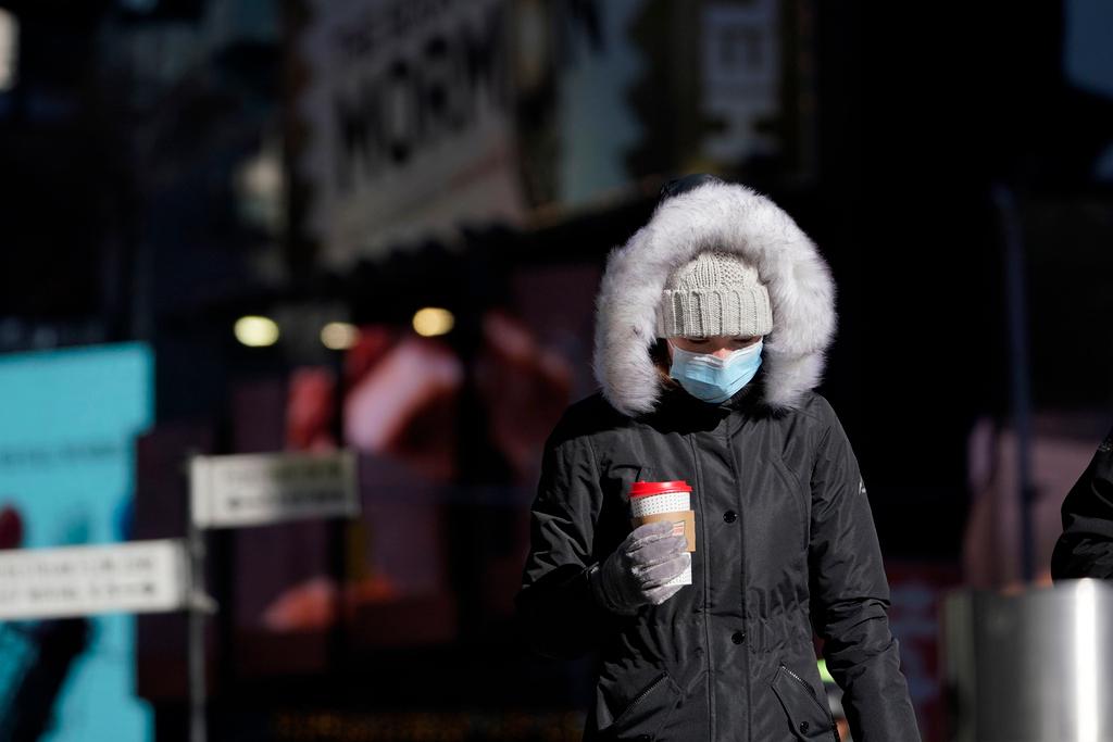 Pedestrian wears a heavy coat against the cold in New York