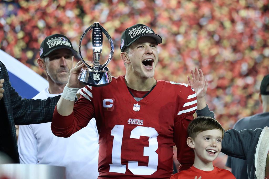 San Francisco 49ers quarterback Brock Purdy (13) and head coach Kyle Shanahan, left, celebrate after the NFC Championship NFL football game against the Detroit Lions 