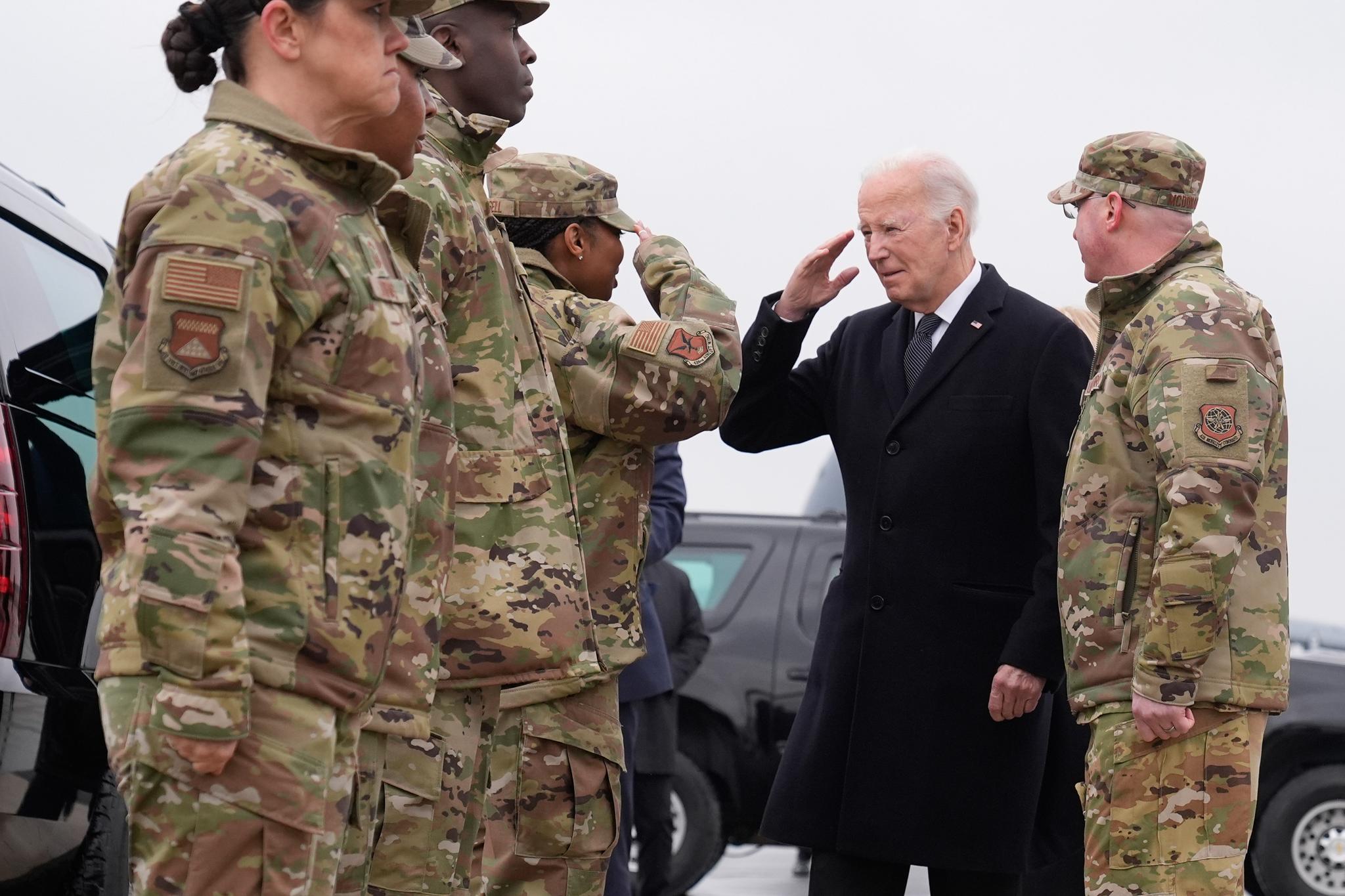 Pres. Biden saluting soldiers in fatigues