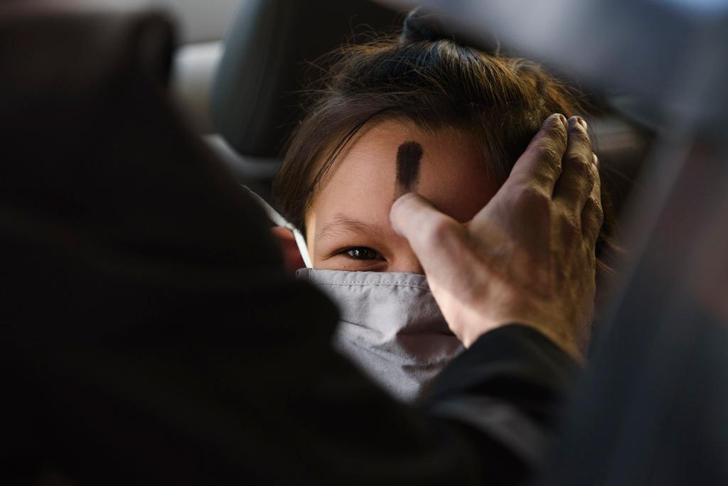 Zoe Gutierrez receives ashes on her forehead for Ash Wednesday, March 2, 2022, in Odessa, Texas. In 2024, Feb. 14 is a holiday heavyweight due to a calendar collision of events — it’s Valentine’s Day and Ash Wednesday.