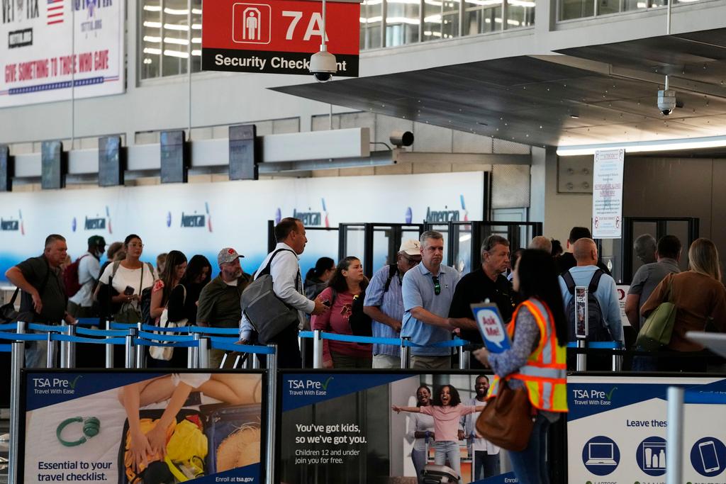 Travelers wait to go through security check point at O'Hare International Airport in Chicago, Aug. 31, 2023. 