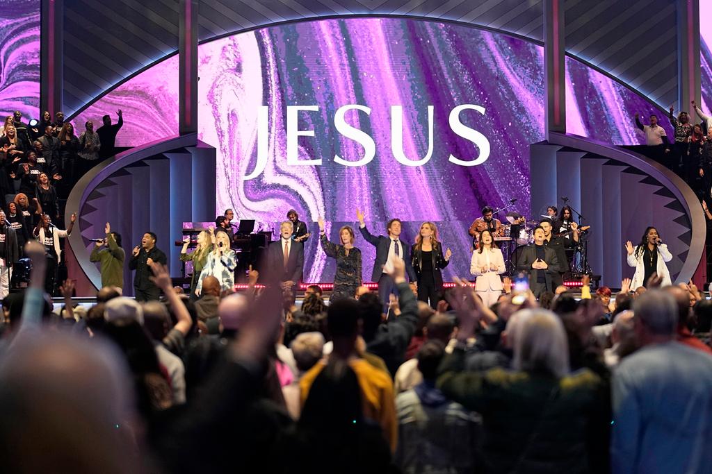 Pastor Joel Osteen leads the congregation in prayer during a service at Lakewood Church 