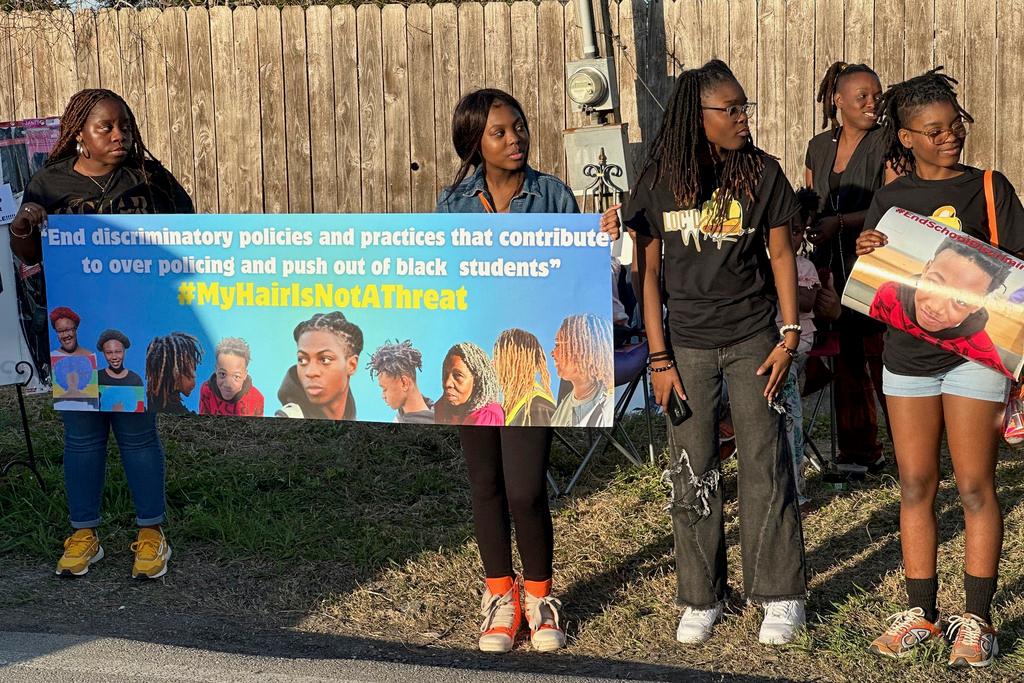 Supporters of Darryl George hold signs during a protest outside of the home of Barbers Hill Independent School District superintendent Greg Poole