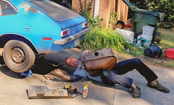 Pastor David working underneath a vehicle