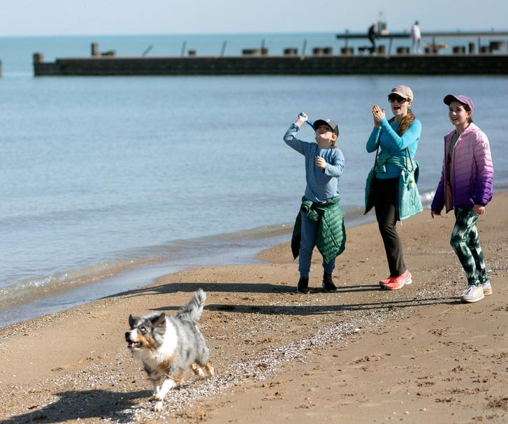  Maria Colavincenzo, center, strolls on the beach of Lake Michigan in Chicago, Sunday, Feb. 25, 2024, with her children, 7-year-old Patrick Galvin, left, and 11-year-old Eloise Galvin, right, and their dog, Greta. 