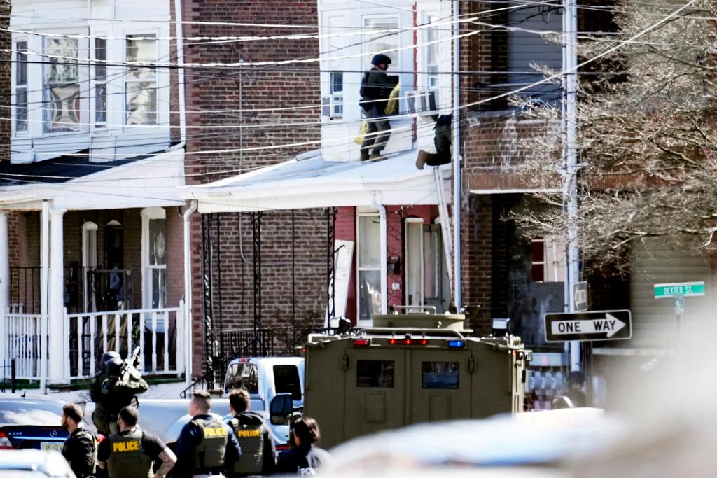 Police surround a home in Trenton, N.J. A suspect has barricaded himself in the home and was holding hostages.