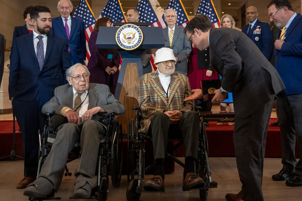 House Speaker Mike Johnson presents Ghost Army member Bernard Bluestein, of Hoffman Estates, Ill., with a medal during a ceremony to honor members of the secretive WWII-era unit 