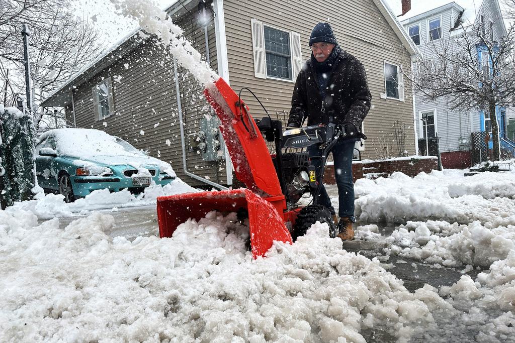 Phil Cloutier removes heavy, wet snow after an early-spring Nor'easter