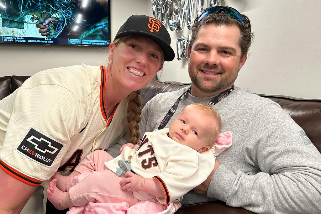 San Francisco Giants assistant coach Alyssa Nakken, left, with her husband, Robert, and their daughter, Austyn, before a baseball game between the Giants and the San Diego Padres 