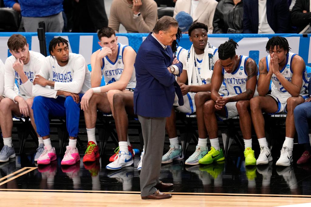 Then - Kentucky coach John Calipari, center, stands in front of the bench late in the second half of the team's basketball game against Oakland 