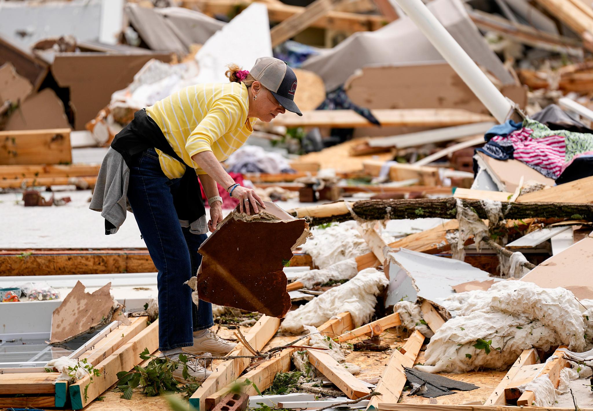 Woman sifts through rubble of home after tornado