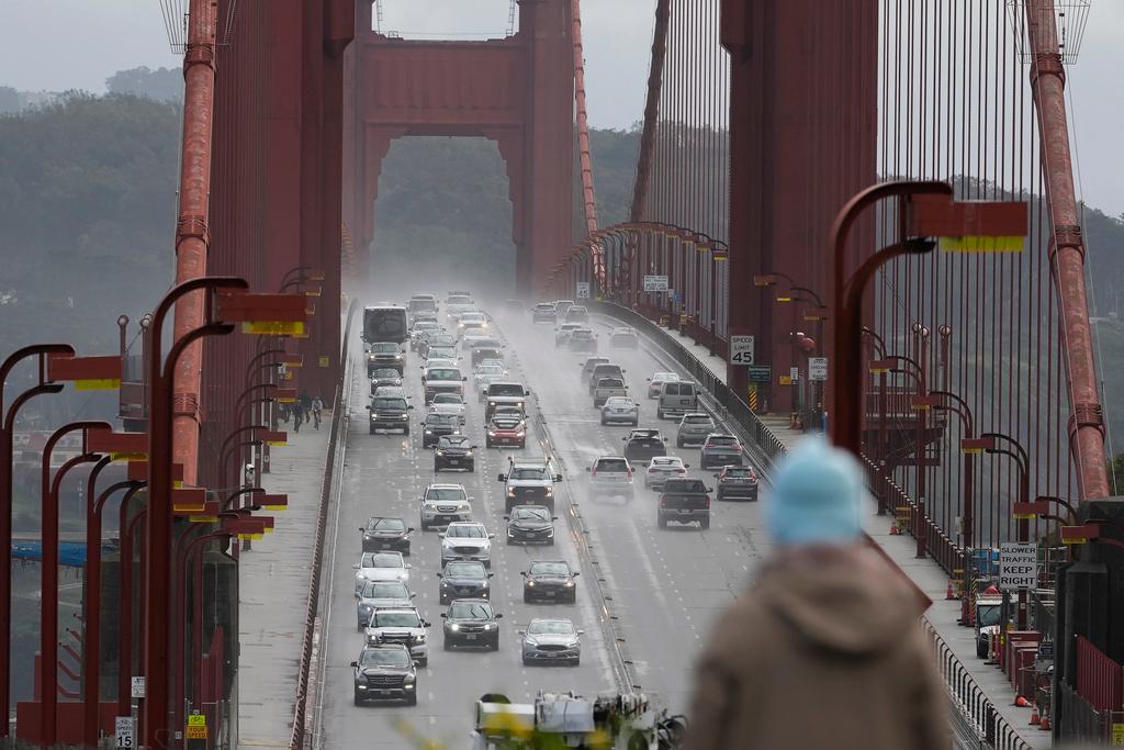 A person watches as traffic drives across the Golden Gate Bridge in Sausalito, Calif., on March 1, 2024. 