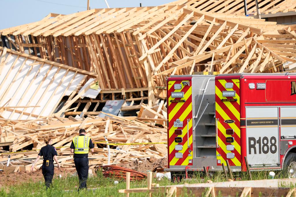 Magnolia Fire officials investigate the scene of a collapsed house