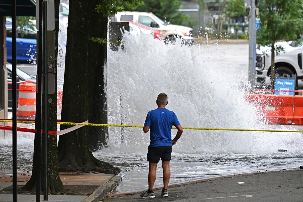 Man watches a water main break