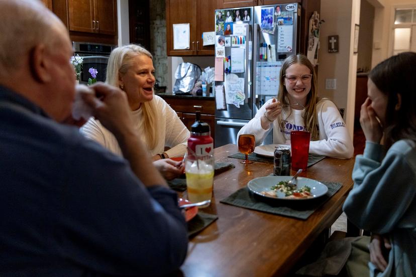Kate Bulkeley, second from right, eats dinner with her family in Westport, Conn.