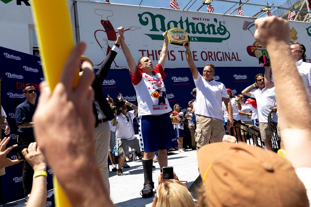 Joey Chestnut, center left, celebrates winning the Nathan's Famous Fourth of July hot dog eating contest in Coney Island on July 4, 2022, in New York.