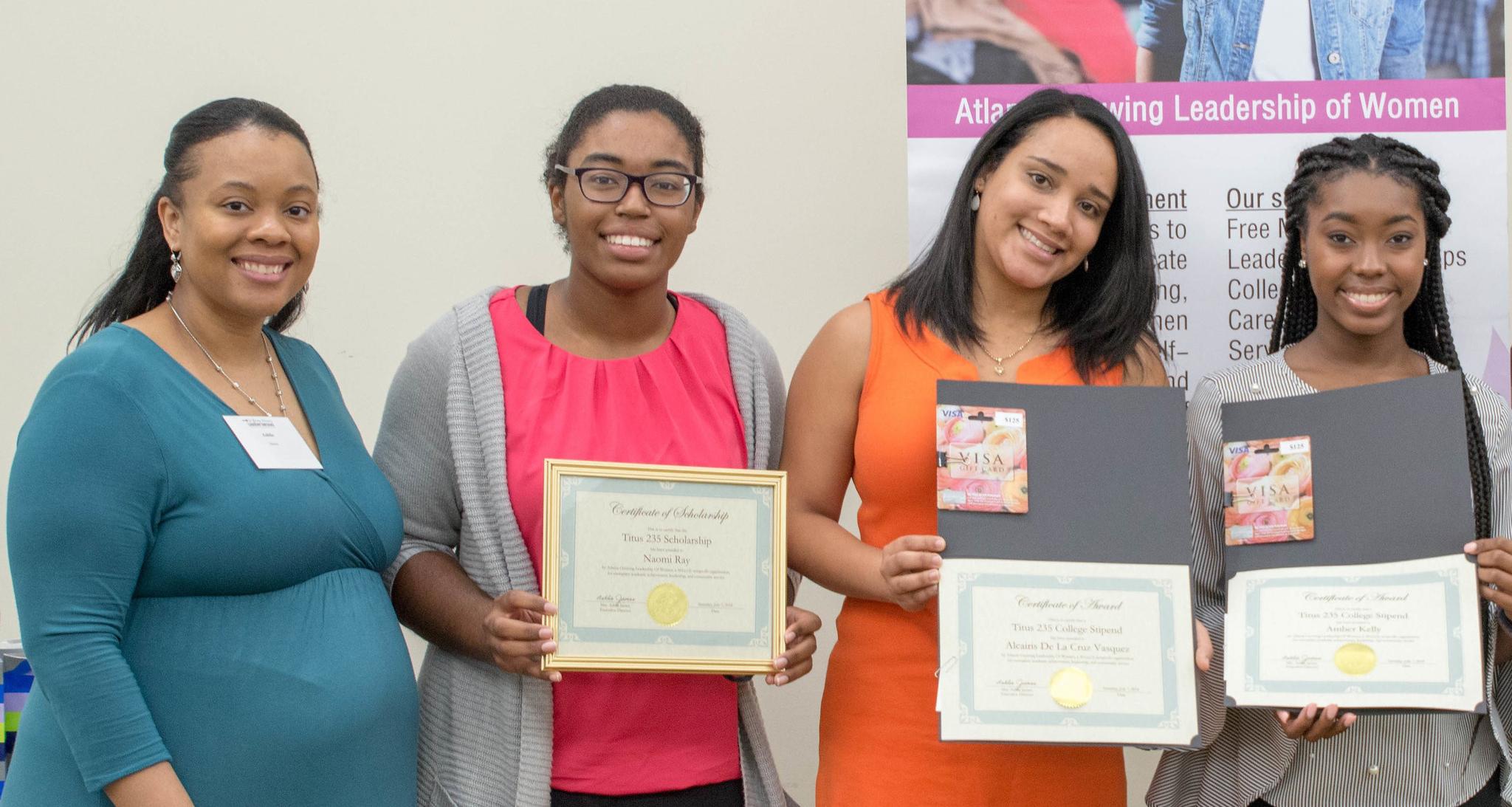 Four women, three holding certificates