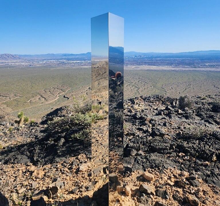 A monolith near Gass Peak, Nev. jutting out of the rocks on a remote mountain peak near Las Vegas, the glimmering rectangular prism's reflective surface imitates the vast desert landscape surrounding the mountain peak where it has been erected. 