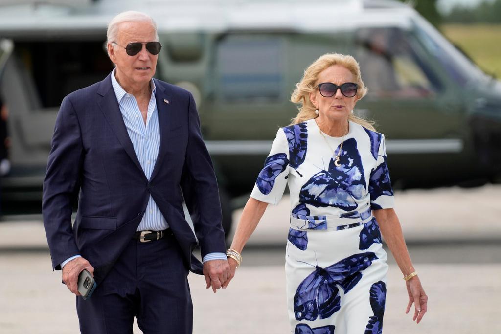 President Joe Biden, left, and first lady Jill Biden arrive on Marine One at East Hampton Airport