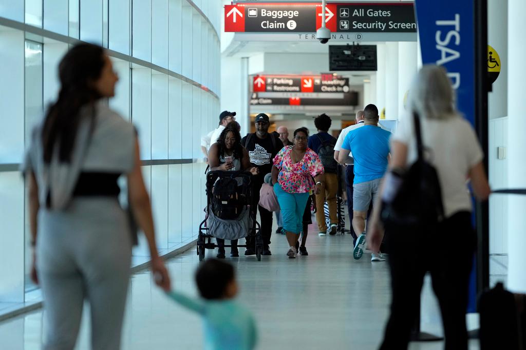 Travelers walk through the Philadelphia International Airport