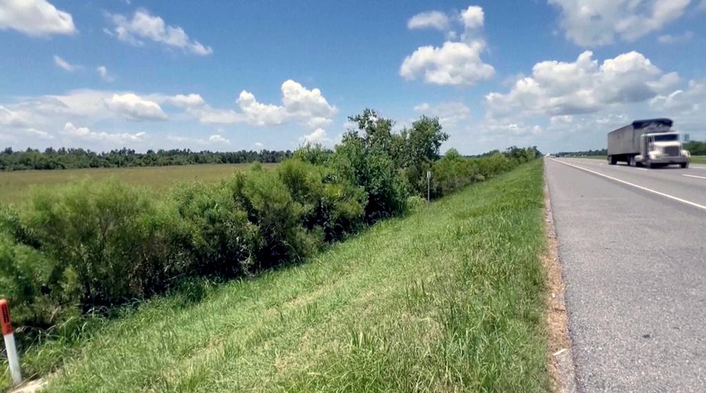 This image made from video provided by KPLC shows a truck passing along the highway where a 1-year-old child was found on Tuesday, July 9, 2024. Speaking at a press conference, Calcasieu Parish Sheriff Gary “Stitch” Guillory said the “miracle baby” survived two days of sometimes stormy weather before a truck driver spotted him crawling along the road the day after his 4-year-old brother was found dead and his mother was arrested in Mississippi.