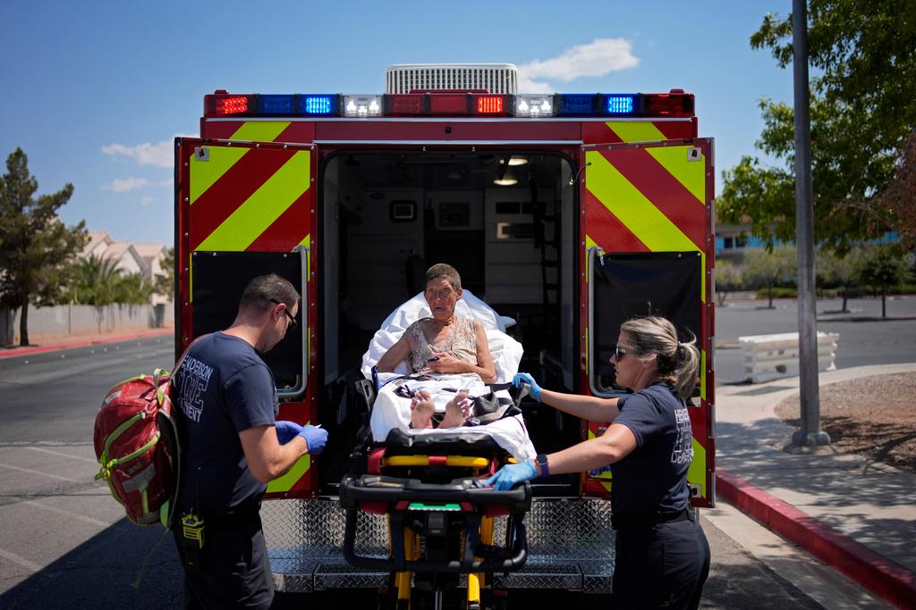 Members of the Henderson Fire Department load Deb Billet, 66, into an ambulance before transporting her to the hospital for heat-related symptoms